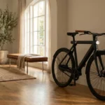 Sleek black electric bicycle parked in a modern minimalist living room with warm sunlight