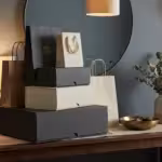 Elegant shopping bags and gift boxes arranged on a console table in a modern home