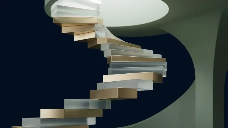 A minimalist spiral staircase featuring alternating steps of brushed gold metal and frosted glass.